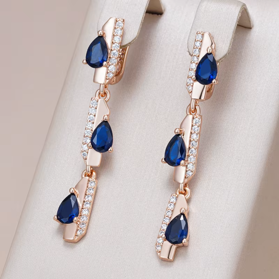 Boucles d'Oreilles Pendantes en Or Rose avec Cristaux Bleus