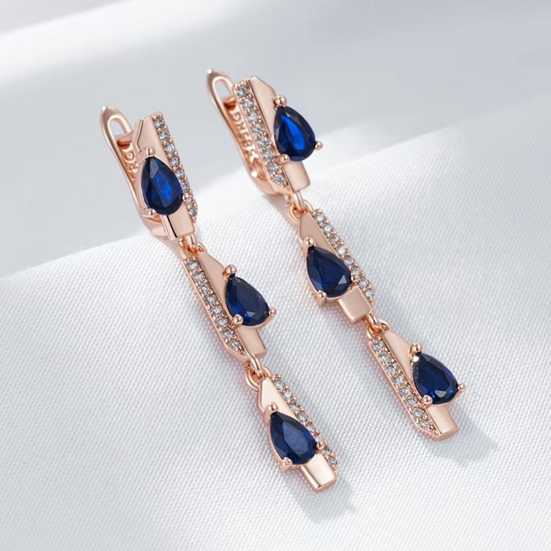 Boucles d'Oreilles Pendantes en Or Rose avec Cristaux Bleus
