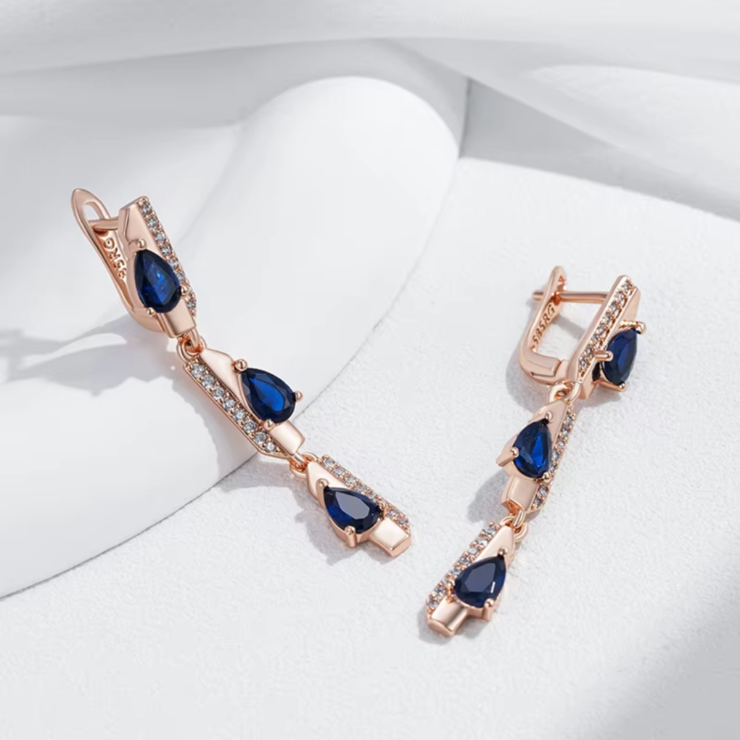 Boucles d'Oreilles Pendantes en Or Rose avec Cristaux Bleus